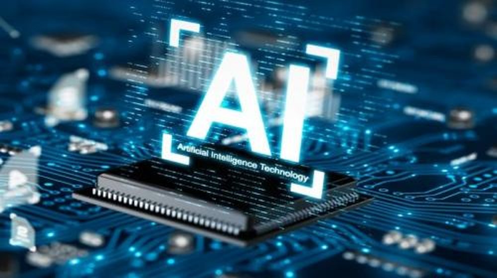 Ilustrasi chip bertuliskan AI di atas papan sirkuit